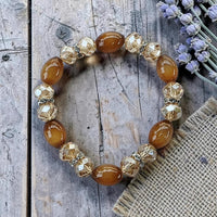Cherry Pit Crafts amber oval beads and clear faceted crystal stretch bracelet with silver accents.