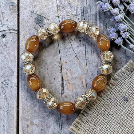 Cherry Pit Crafts amber oval beads and clear faceted crystal stretch bracelet with silver accents.