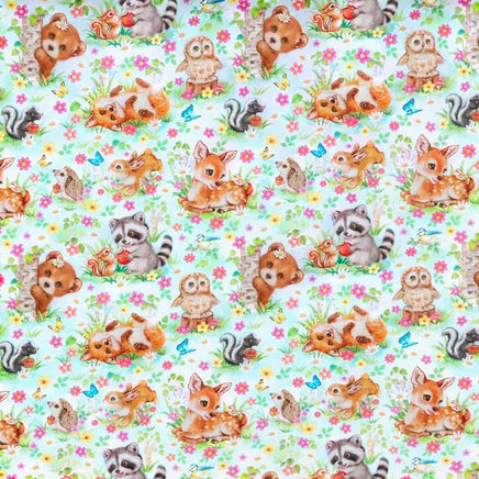 Cherry Pit Crafts 100% cotton fabric with a cute animal pattern featuring bears, owls, deer, raccoons, squirrels, and skunks on a light blue floral background.