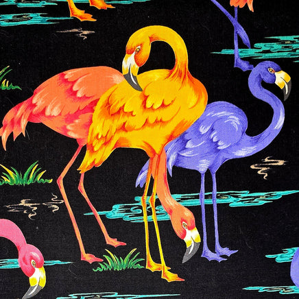 Cherry Pit Crafts microwaveable heating pad with a black background and a vibrant animal pattern featuring flamingos in orange, yellow, purple, and pink.