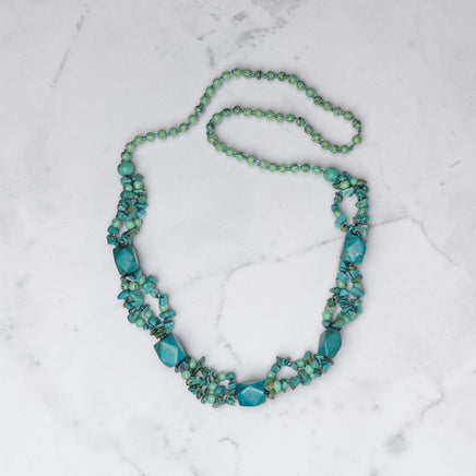 Handmade Cherry Pit Crafts turquoise beaded necklace with natural stone variations. Features multiple strands of turquoise chips and polished stones.