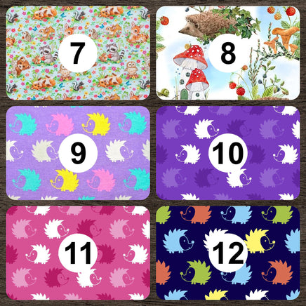 Cherry Pit Crafts microwaveable heating pad with animal pattern featuring hedgehogs in various colors on purple background.
