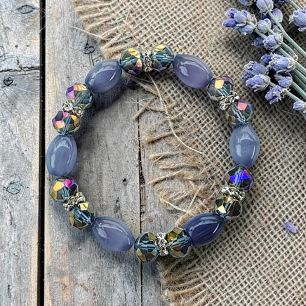 Cherry Pit Crafts lavender and iridescent faceted crystal beaded stretch bracelet with smooth oval beads.