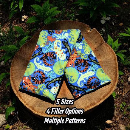 Cherry Pit Crafts blue heating pad with colorful lizard pattern, made of 100% cotton.