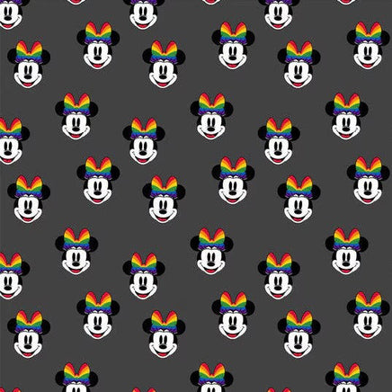 Cherry Pit Crafts microwaveable heating pad with repeating pattern of Minnie Mouse heads wearing rainbow bows on a dark grey background.