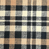 Cherry Pit Crafts plaid flannel heating pad in black, tan, and cream with a textured dot pattern.