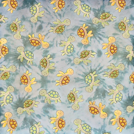 Cherry Pit Crafts microwaveable heating pad with cute cartoon turtles on a blue tie-dye background. 100% cotton.
