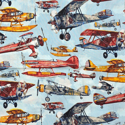 Cherry Pit Crafts vintage airplane print heating pad fabric with biplanes and seaplanes in red, yellow, and blue.