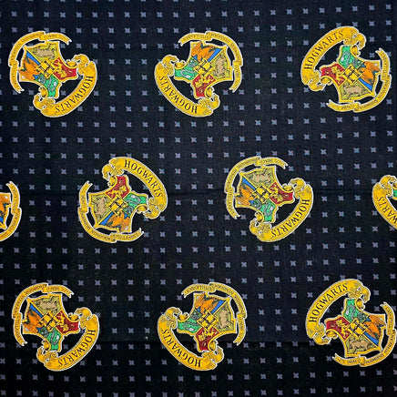 Pattern of Hogwarts crest logos on a dark fabric background