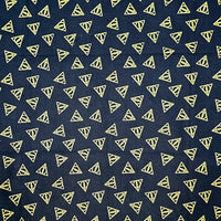 Navy blue fabric with small yellow triangle patterns