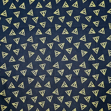Navy blue fabric with small yellow triangle patterns